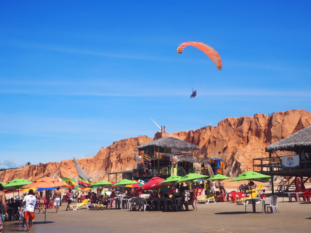 Brésil, Céara, nordeste : Plage de Canoa Quebrada, avec activités sportives comme le parapente et kitesurf.